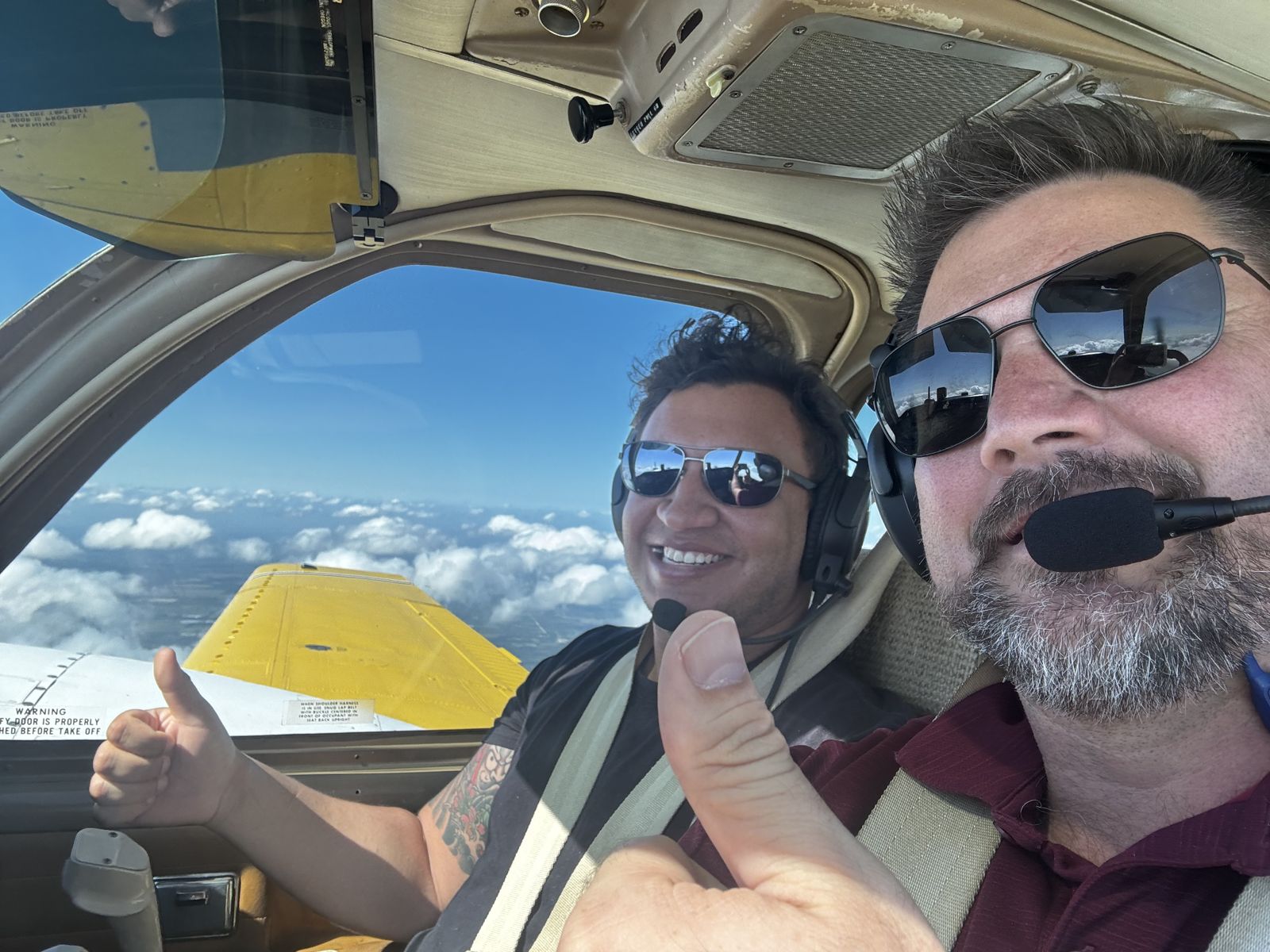 Thumbs up in the cockpit above the clouds
